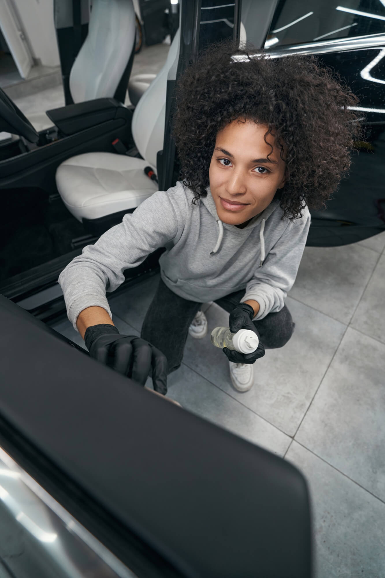 Professional detailer working on a vehicle interior