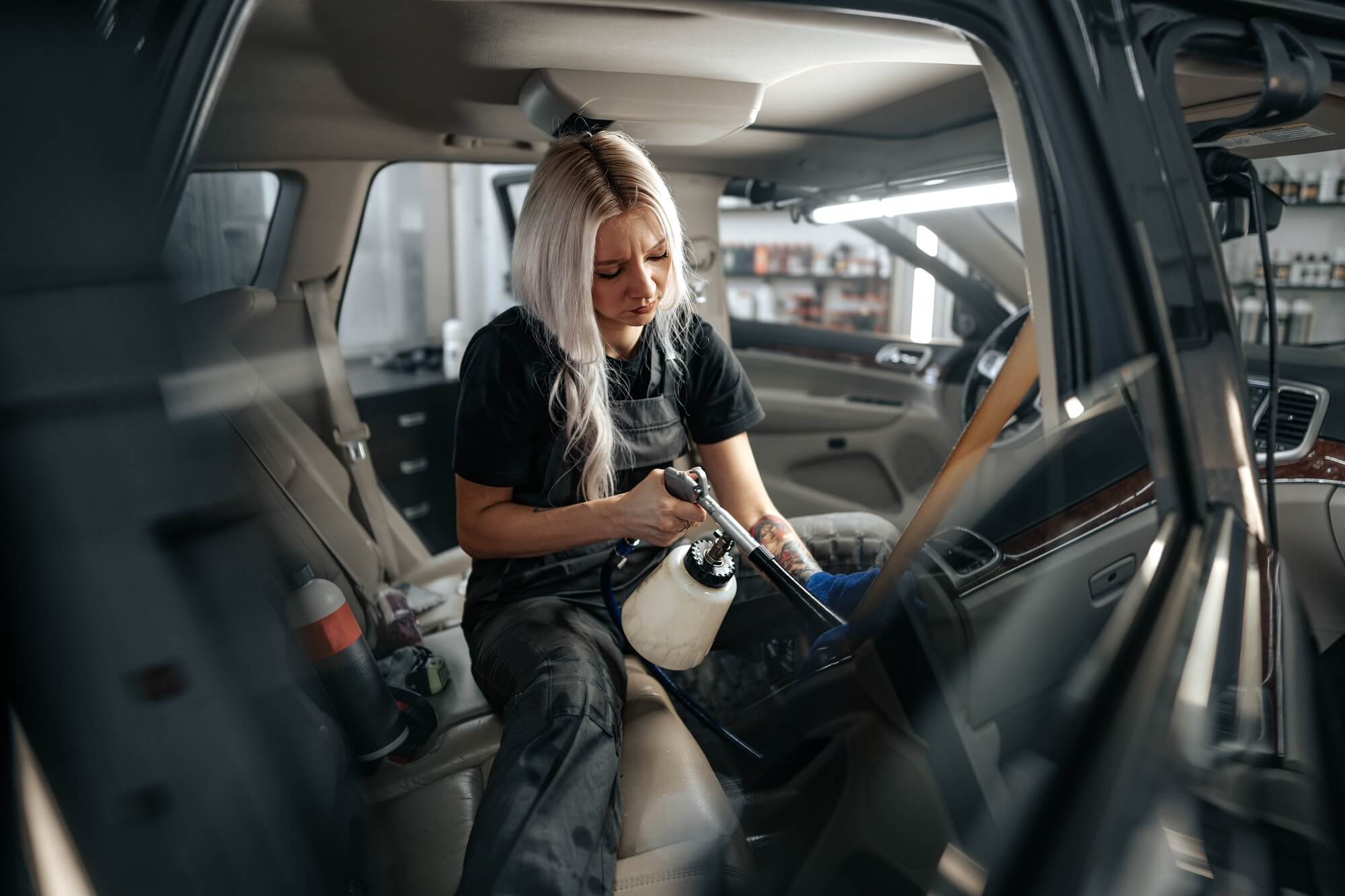 Detailer carefully cleaning the interior of a vehicle
